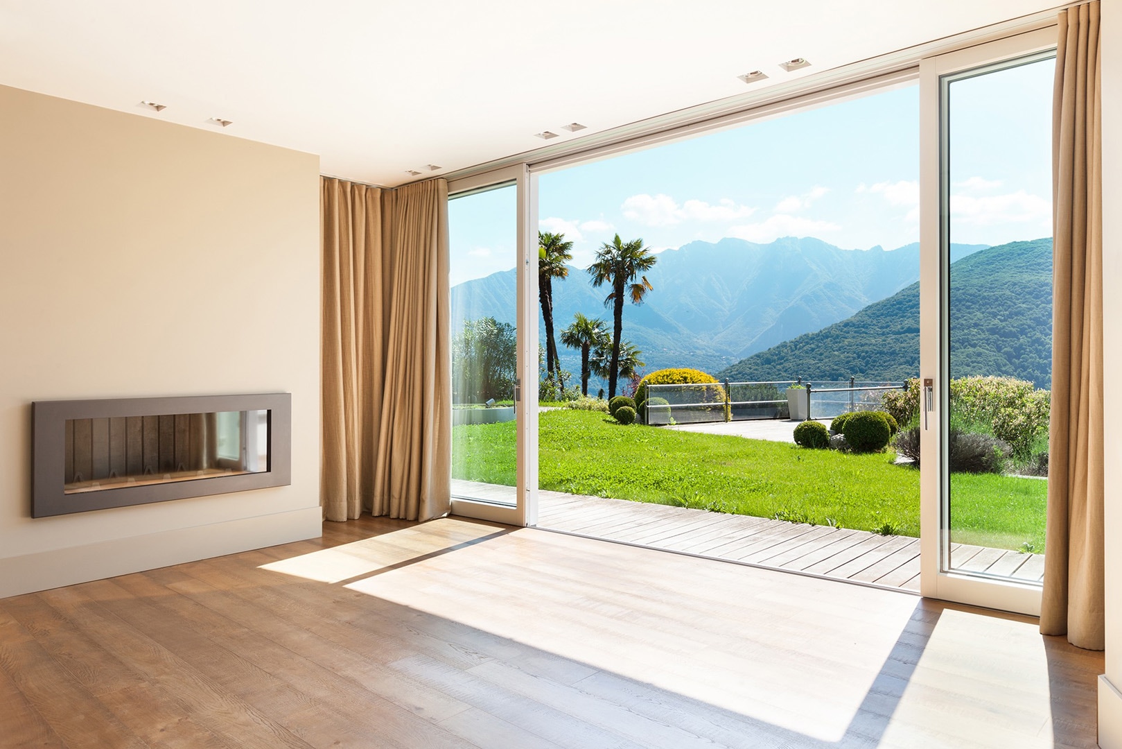 patio doors leading out into modern garden with mountain views