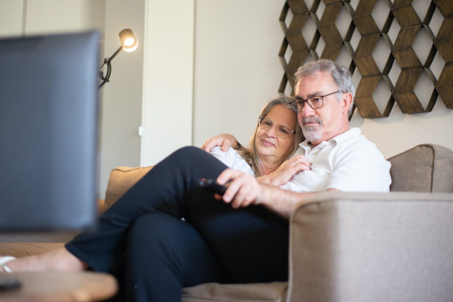 mature couple embracing on living room sofa