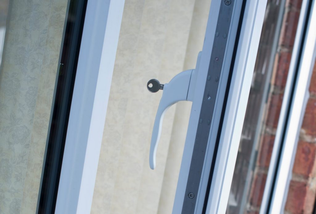 Close-up of an espag window handle on a conservatory, displaying its sleek design and secure locking mechanism, which contributes to the conservatory's modern functionality and enhanced security features.