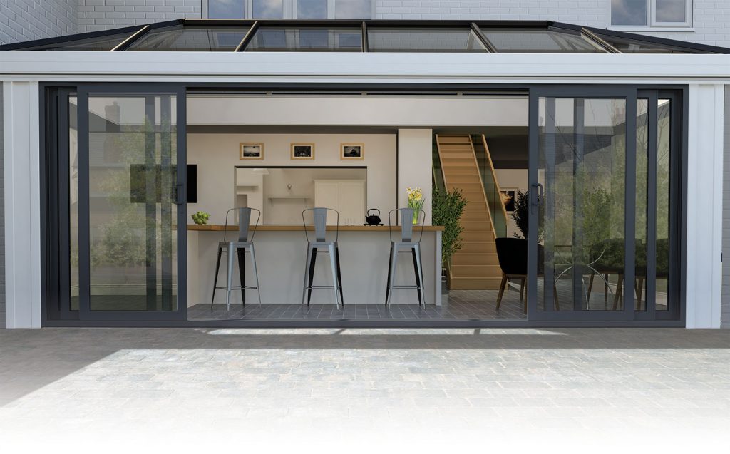 Stylish modern glazed extension with floor-to-ceiling windows and a minimalist design, offering a panoramic view of the garden and enhancing the home's architectural appeal.