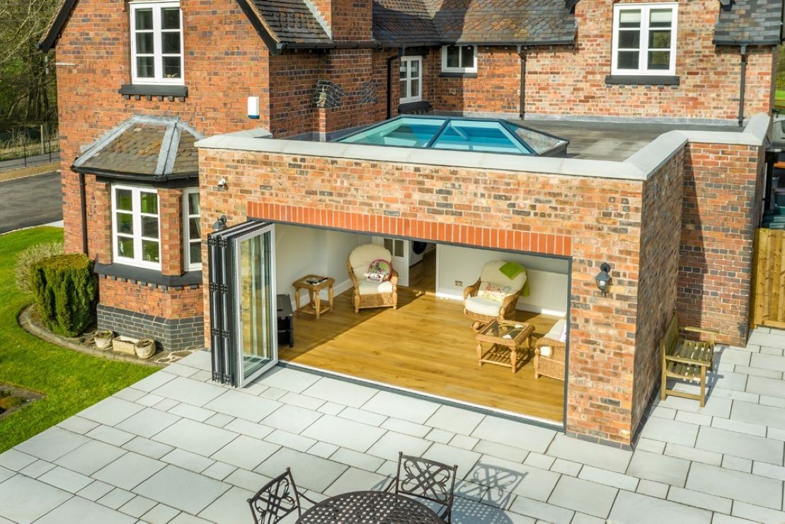 modern glazed house extension with fully opened bifold doors