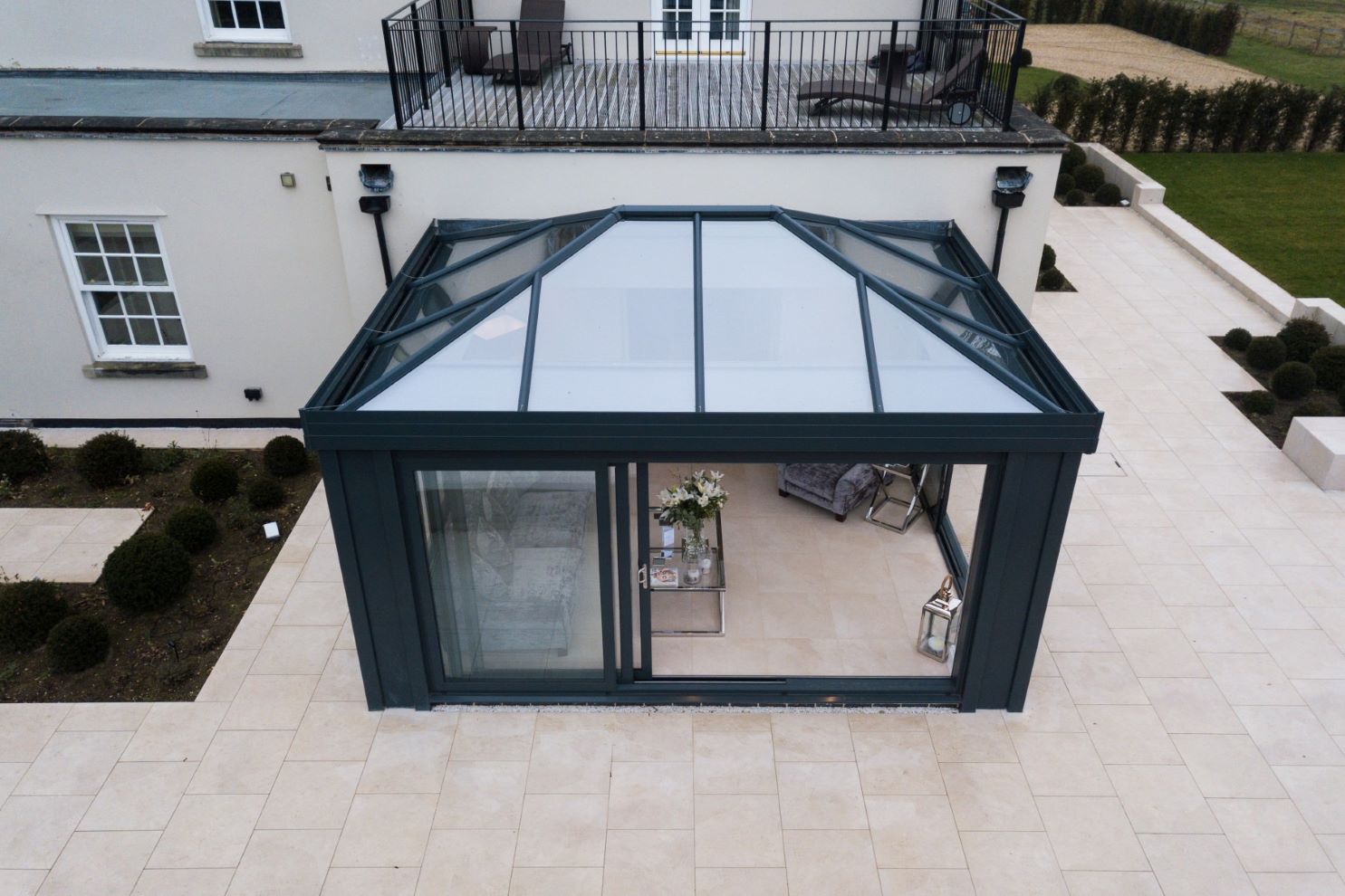 aerial view of modern black conservatory with glass roof and sliding doors
